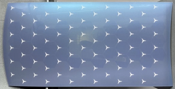 Foil application test sample with a repeating three-pointed star pattern
